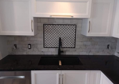 Installation of a metro-style marble backsplash with insert (custom-made) call an electrician to make the final connection.
